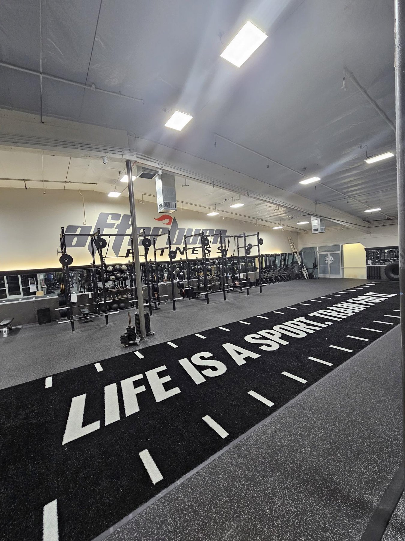 FFP turf sprint track with "Life Is A Sport" markings at AB Fitness