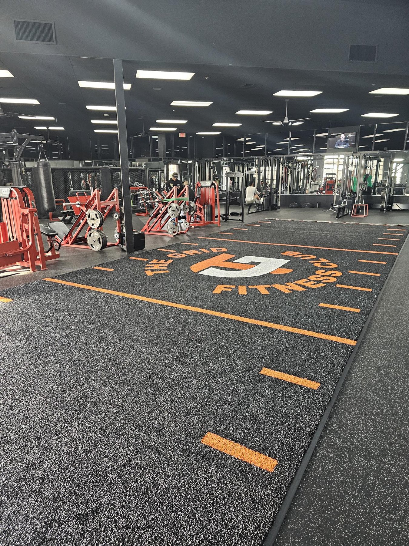 Black FFP turf with orange logo markings at The Grid Fitness Club